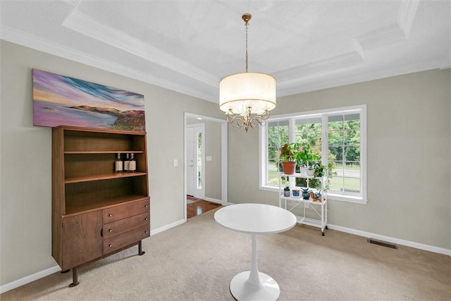 715 W Coolidge Ave, Charleston, IL 61920 - carpeted dining area featuring crown molding, a tray ceiling, and a chandelier