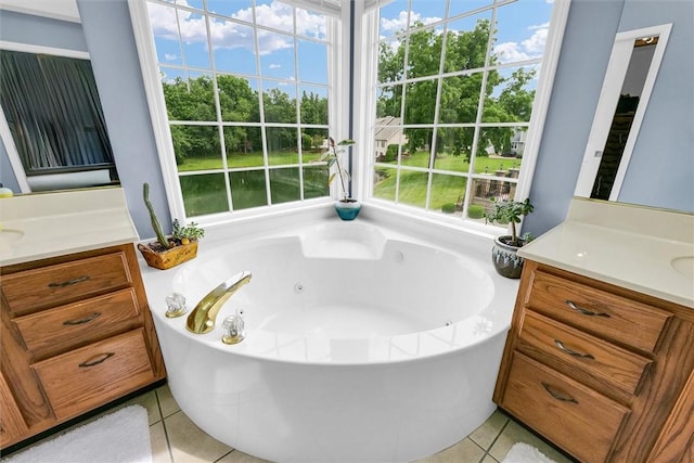 715 W Coolidge Ave, Charleston, IL 61920 - bathroom featuring vanity, a jetted tub, tile patterned floors, and view of wooded area