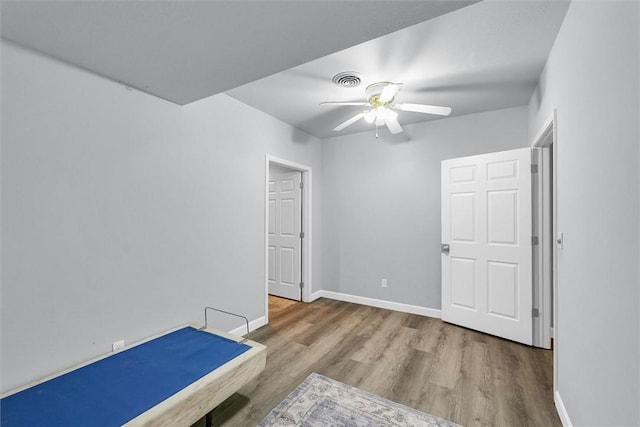 715 W Coolidge Ave, Charleston, IL 61920 - unfurnished bedroom featuring wood finished floors and ceiling fan