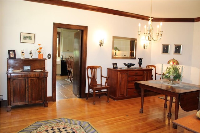 300 W N 1st St, Shelbyville, IL 62565 - dining room with light wood-type flooring, a chandelier, and crown molding