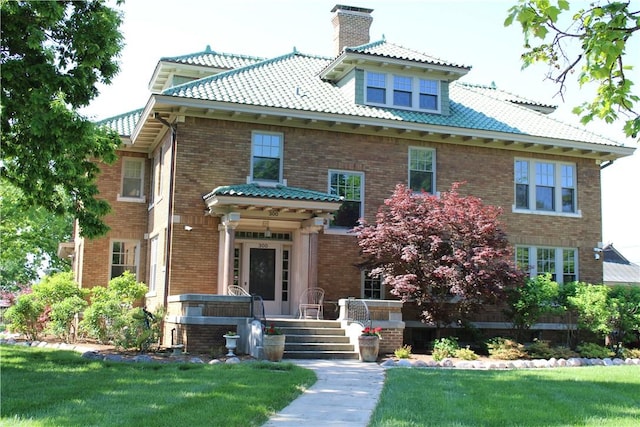 300 W N 1st St, Shelbyville, IL 62565 - view of front of property with a chimney, a front yard, brick siding, and a tiled roof