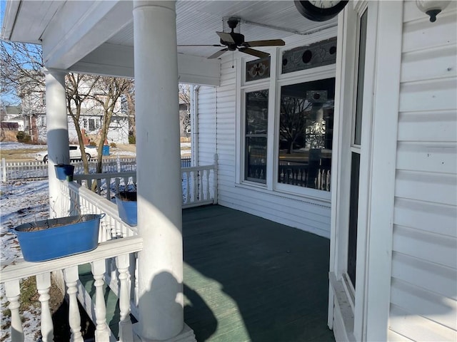 snow covered patio featuring ceiling fan