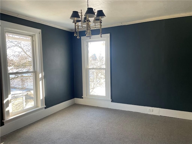 carpeted empty room featuring a notable chandelier and crown molding