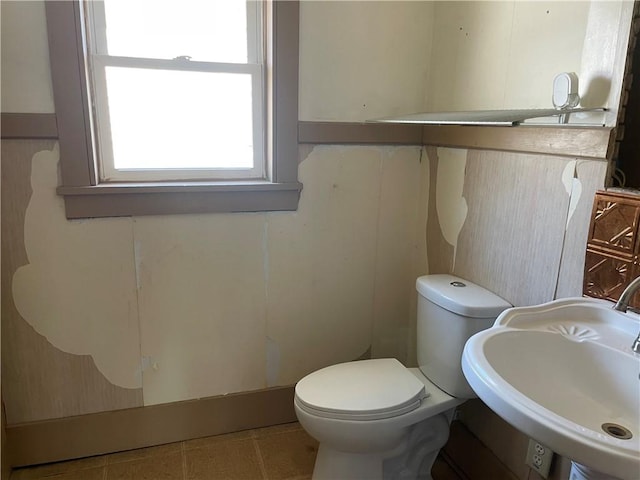 bathroom with tile patterned floors, toilet, and sink