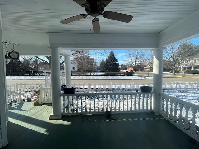 deck featuring ceiling fan, a porch, and a water view