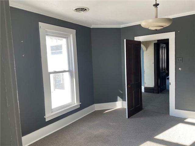 carpeted empty room with crown molding