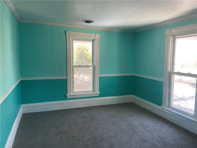 unfurnished room featuring carpet, plenty of natural light, and ornamental molding