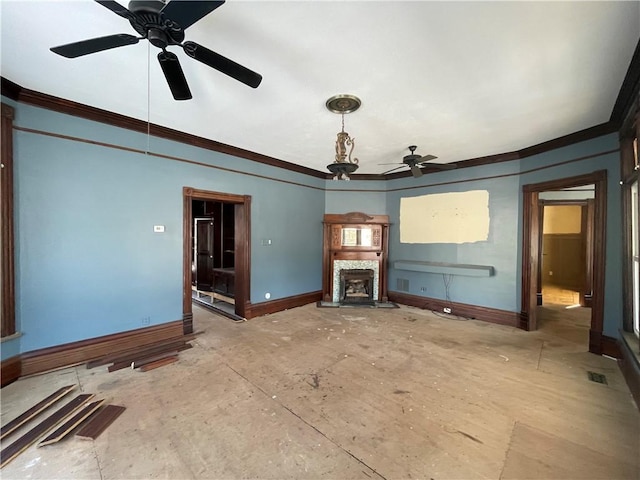 unfurnished living room featuring crown molding, a fireplace, and ceiling fan