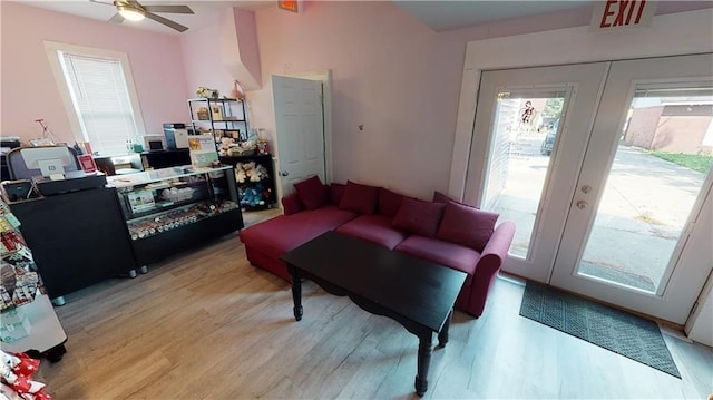 living room featuring ceiling fan, french doors, and light wood-type flooring