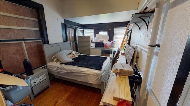 bedroom with dark hardwood / wood-style floors