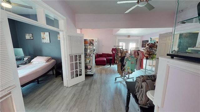 bedroom with ceiling fan, french doors, and light hardwood / wood-style floors