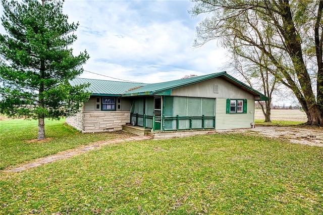 18004 N 2180th St, Marshall, IL 62441 - view of front of house with stone siding, a front yard, and a metal roof