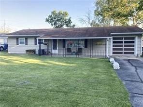 single story home featuring a garage and a front yard