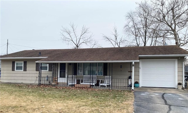 single story home featuring a garage, a front yard, and covered porch