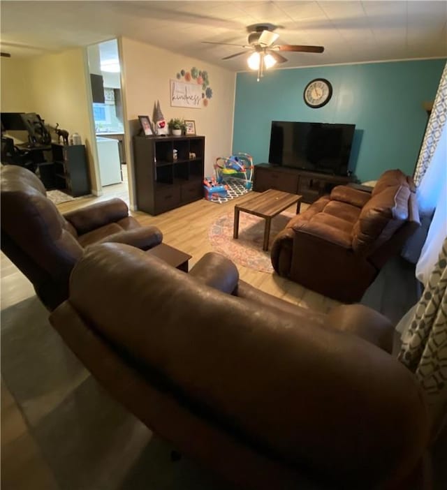 living room featuring wood-type flooring and ceiling fan