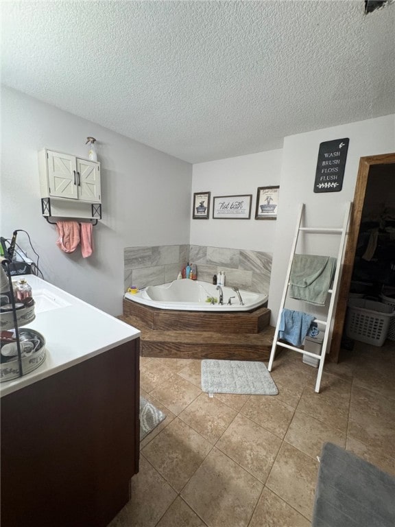 6414 300th Rd, Martinsville, IL 62442 - bathroom featuring a textured ceiling, a garden tub, vanity, and tile patterned flooring