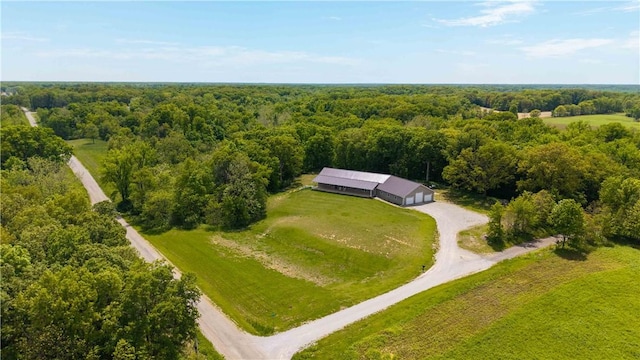view of subject property with a heavily wooded area