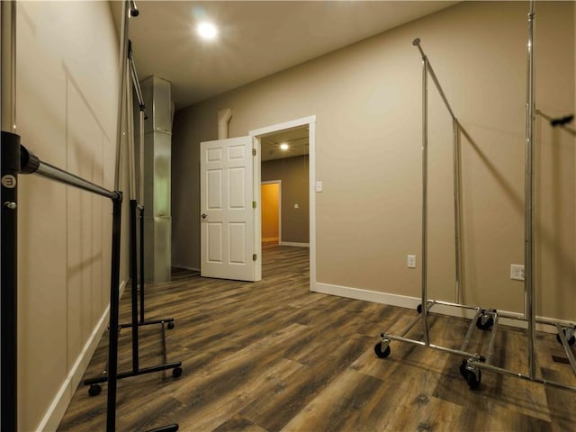 basement with dark wood-type flooring and baseboards