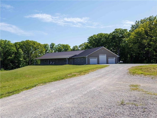 single story home featuring a front lawn, driveway, and a garage