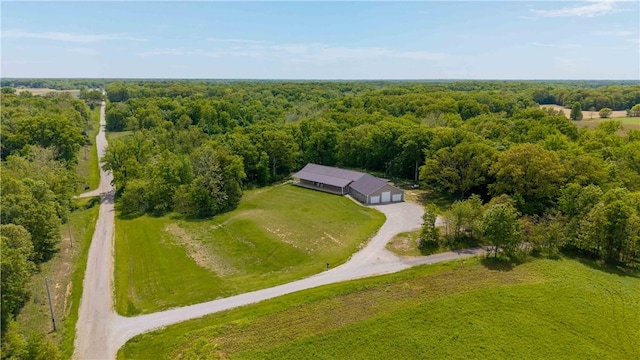 view of subject property with a heavily wooded area