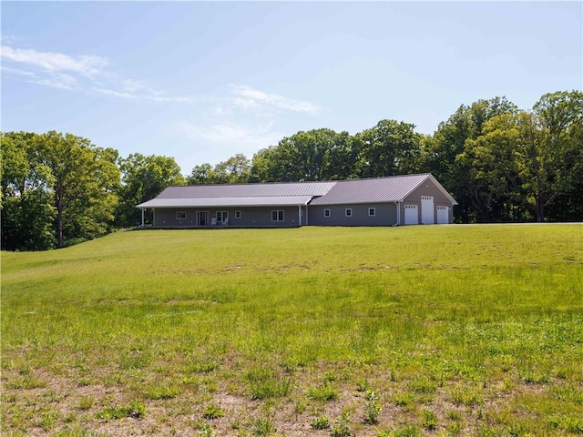 view of front of property featuring a front yard and metal roof