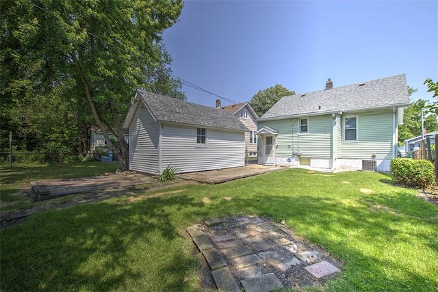 1263 E Dickinson Ave, Decatur, IL 62521 - back of house with a yard, an outdoor structure, and a chimney
