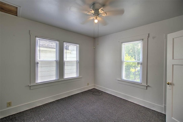 1263 E Dickinson Ave, Decatur, IL 62521 - empty room with dark colored carpet and a ceiling fan