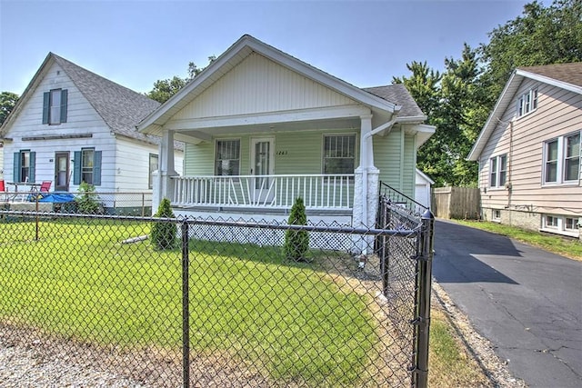 1263 E Dickinson Ave, Decatur, IL 62521 - view of front of home with a porch, an outdoor structure, roof with shingles, and board and batten siding