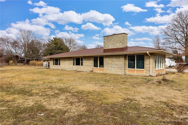 rear view of property featuring a yard