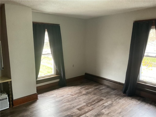 unfurnished room featuring a textured ceiling and hardwood / wood-style flooring