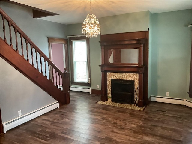 unfurnished living room with a baseboard radiator, an inviting chandelier, and dark wood-type flooring