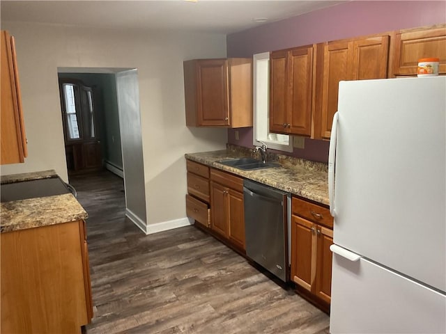 kitchen featuring dark wood-type flooring, white refrigerator, sink, stainless steel dishwasher, and baseboard heating