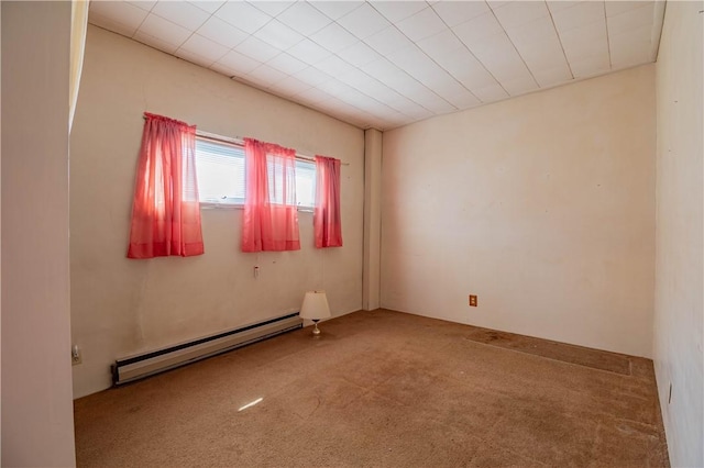 carpeted empty room featuring baseboard heating