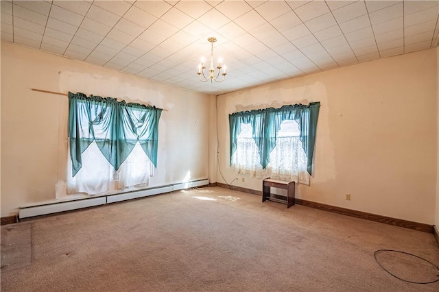 empty room featuring a notable chandelier, baseboards, a baseboard heating unit, and carpet