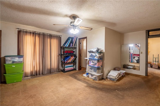 interior space with a textured ceiling and ceiling fan