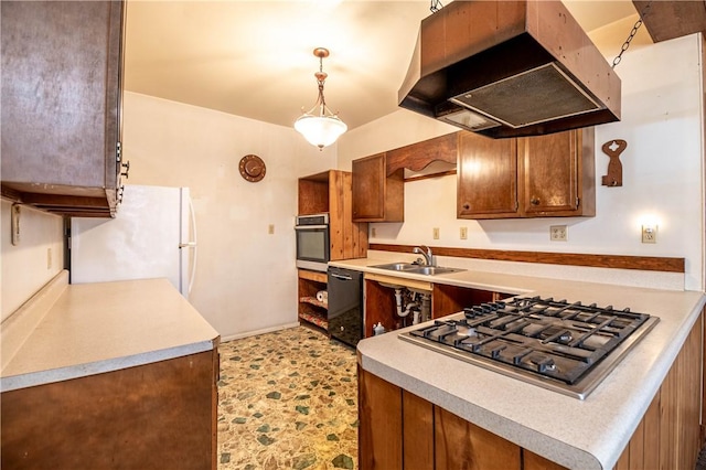 kitchen with under cabinet range hood, light countertops, appliances with stainless steel finishes, and a sink