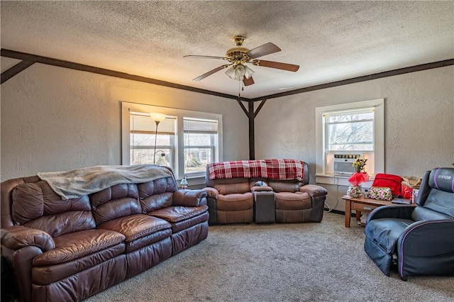 carpeted living area with a healthy amount of sunlight, a textured ceiling, ceiling fan, and a textured wall