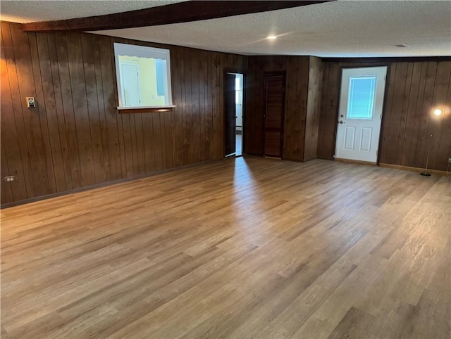 824 Kenton Dr, Charleston, IL 61920 - empty room featuring a textured ceiling, wood finished floors, wood walls, and beamed ceiling