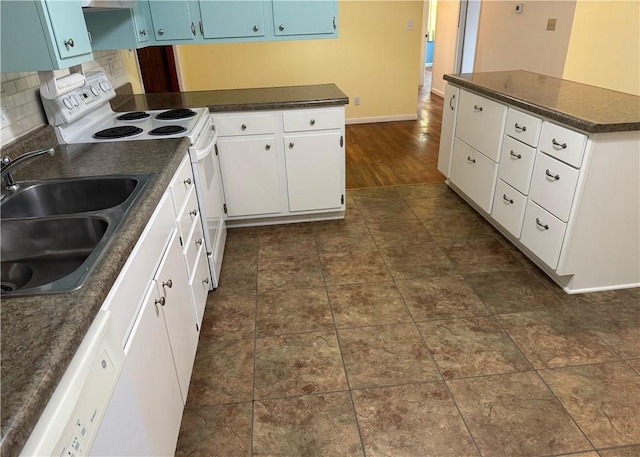 824 Kenton Dr, Charleston, IL 61920 - kitchen with white appliances, dark countertops, blue cabinets, tasteful backsplash, and a peninsula