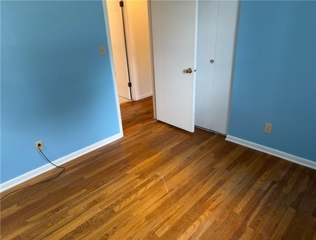 824 Kenton Dr, Charleston, IL 61920 - unfurnished bedroom with wood finished floors and a closet