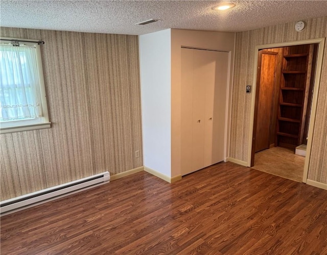 824 Kenton Dr, Charleston, IL 61920 - spare room with baseboard heating, a textured ceiling, wood finished floors, a smoke detector, and wallpapered walls