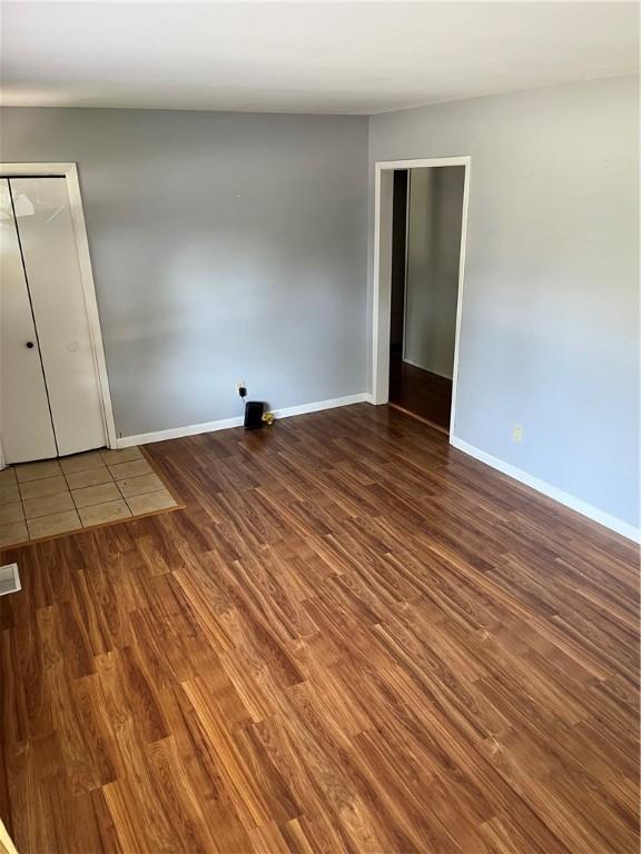 1021 W Hayes Ave, Charleston, IL 61920 - unfurnished bedroom featuring wood finished floors and baseboards