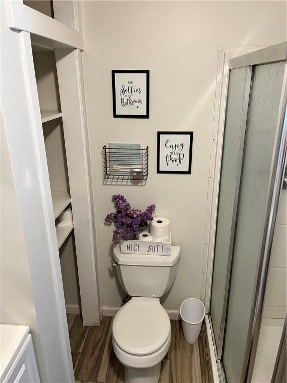 1021 W Hayes Ave, Charleston, IL 61920 - bathroom with wood finished floors, a shower stall, and vanity
