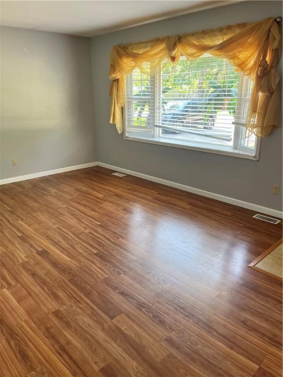 1021 W Hayes Ave, Charleston, IL 61920 - unfurnished room featuring wood finished floors and baseboards