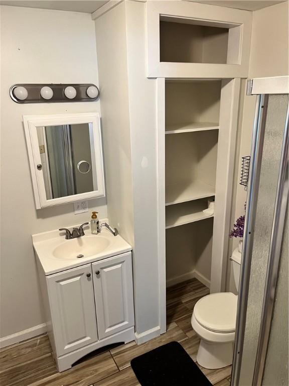 1021 W Hayes Ave, Charleston, IL 61920 - bathroom featuring vanity and wood finished floors