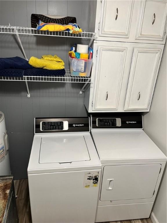 1021 W Hayes Ave, Charleston, IL 61920 - laundry room featuring cabinet space, independent washer and dryer, and water heater