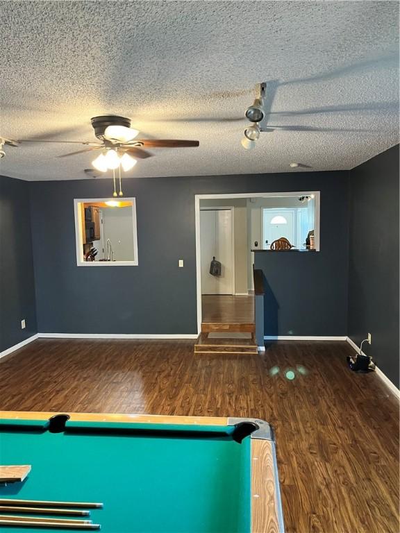 1021 W Hayes Ave, Charleston, IL 61920 - recreation room featuring wood finished floors, a textured ceiling, and a ceiling fan