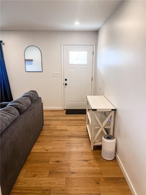 foyer entrance featuring light wood-style floors and baseboards