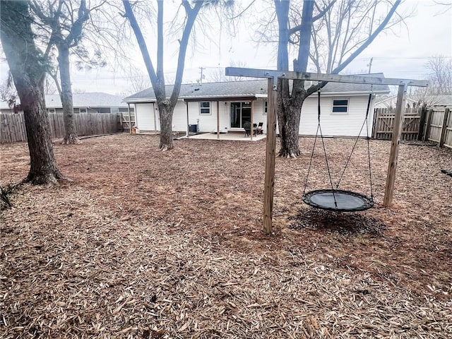 rear view of house with a patio area and a fenced backyard