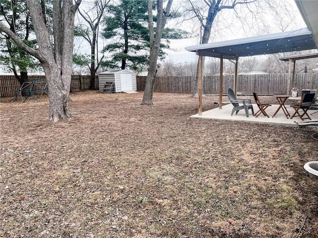 view of yard featuring an outbuilding, a fenced backyard, a patio, and a storage shed